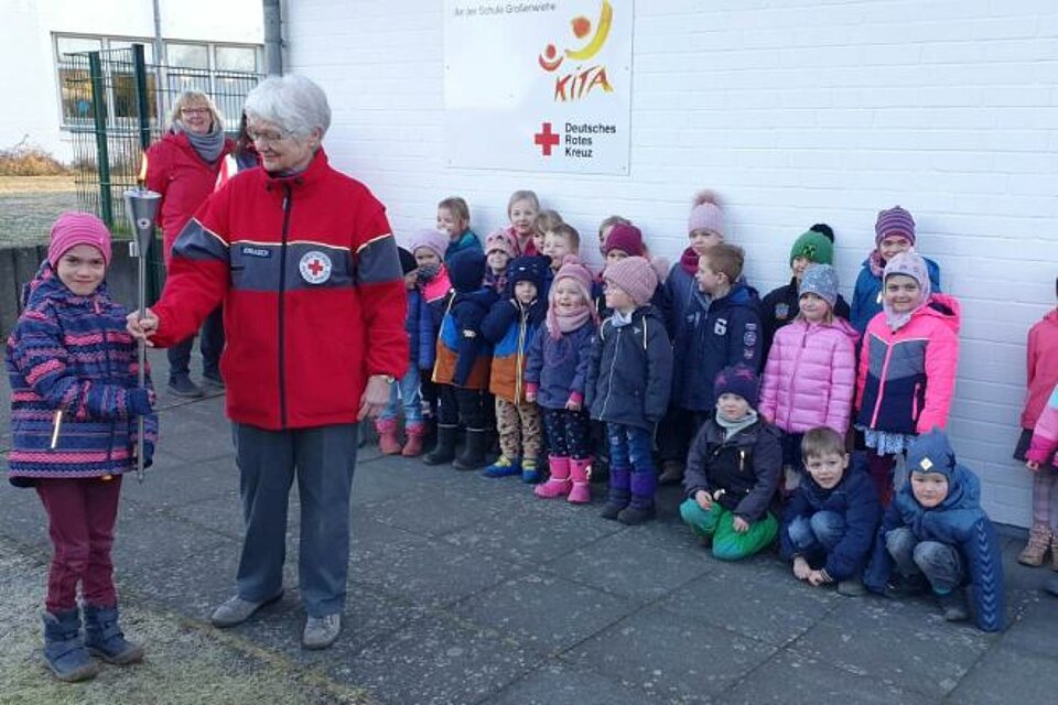 Fackellauf_LV_SH_KV_Nordfriesland1 Lena (links) von der DRK Kindertagesstätte an der Schule in Großenwiehe (Kreis Schleswig-Flensburg) das Licht der Hoffnung an Inge Jorasch, stellvertretend für den Kreisverband Nordfriesland