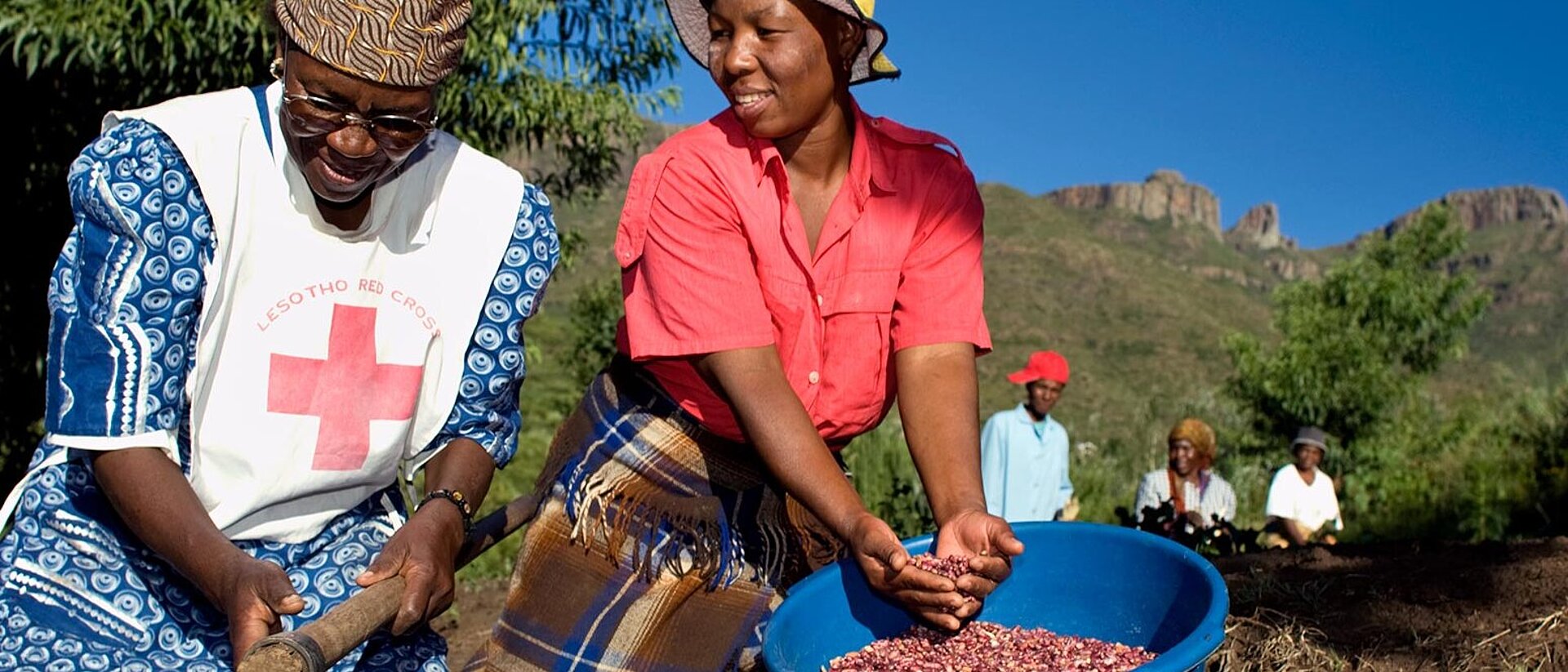 Two women spreading seeds