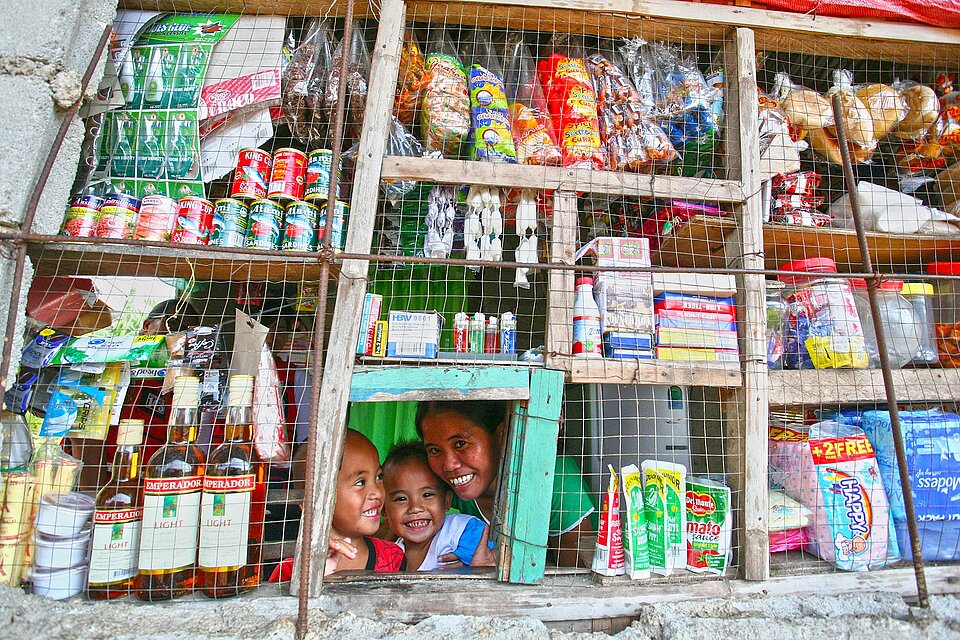 Woman an children looking trough shop window