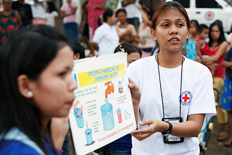 Volunteer showing a poster