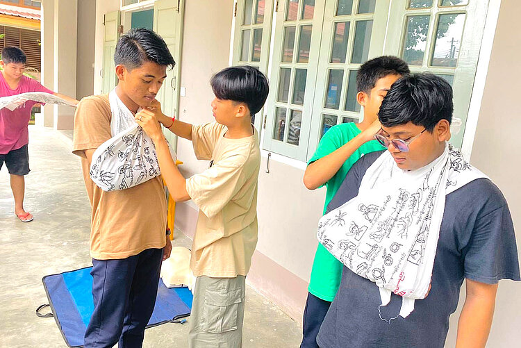 Boys practicing first aid