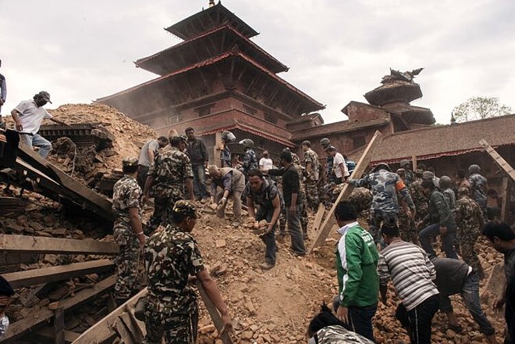 Erdbeben in Nepal Trümmer und Menschen vor Tempel