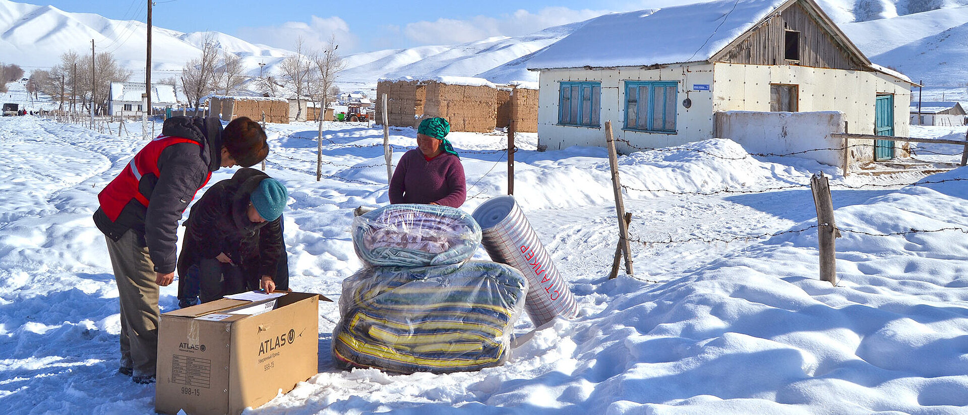 People in snow with relief items
