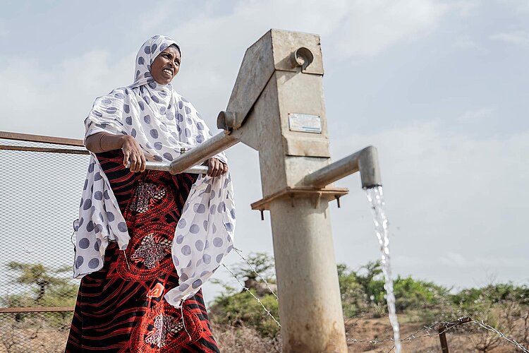 Ethiopian woman using a new well