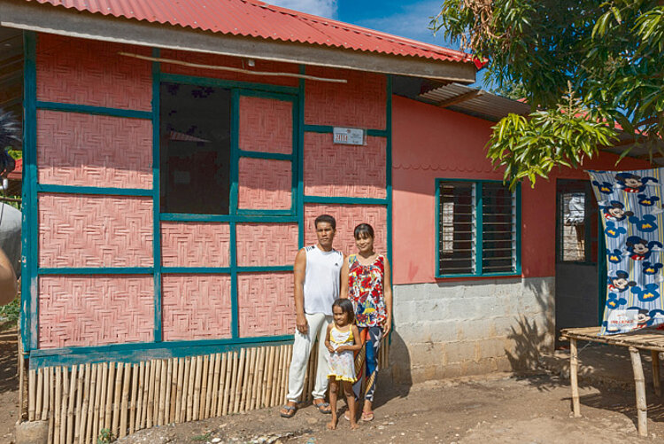 Family in front of new house