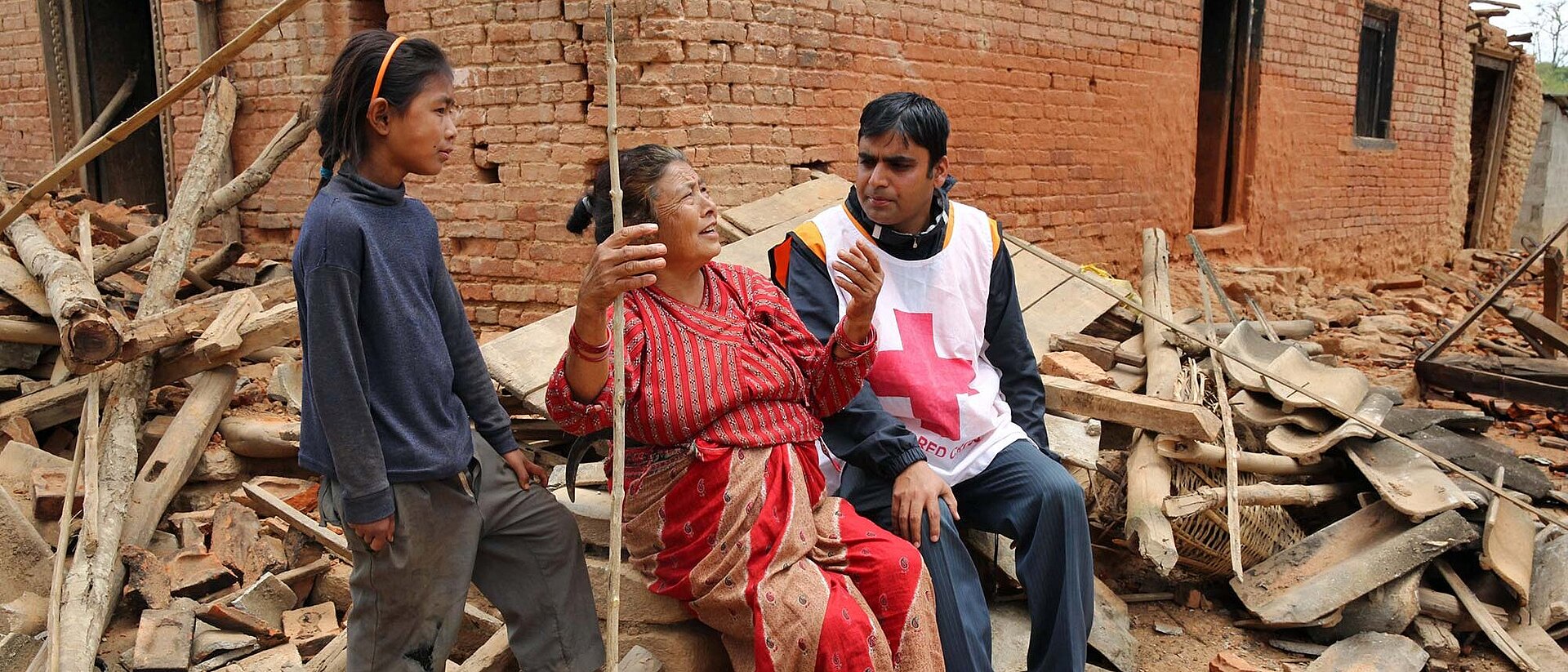 Woman, girl and volunteer in debris