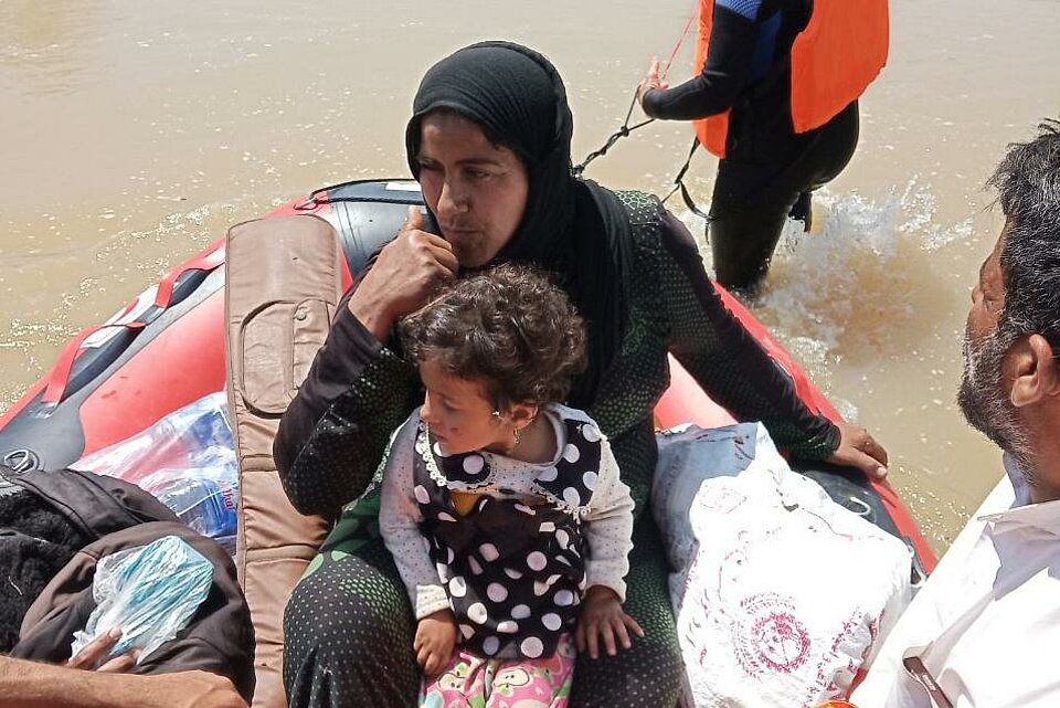 Der Iranische Rote Halbmond im Einsatz nach Überschwemmungen im Iran Mutter und Kinder im DRK Rettungsboot beim Rettungseinsatz des Iranischen Roten Halbmonds