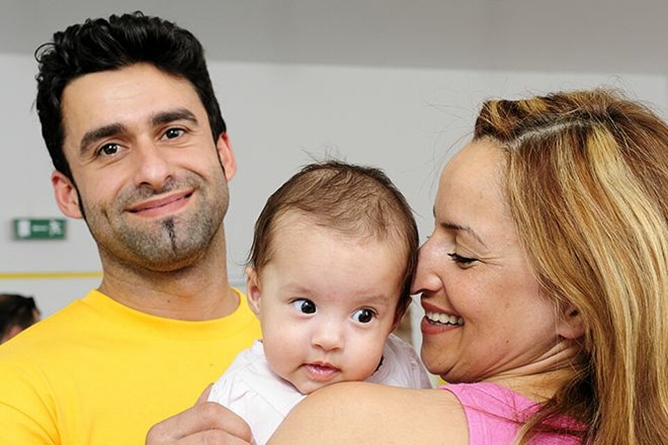 Untersützung für Familen Ein Paar mit einem Baby auf dem Arm