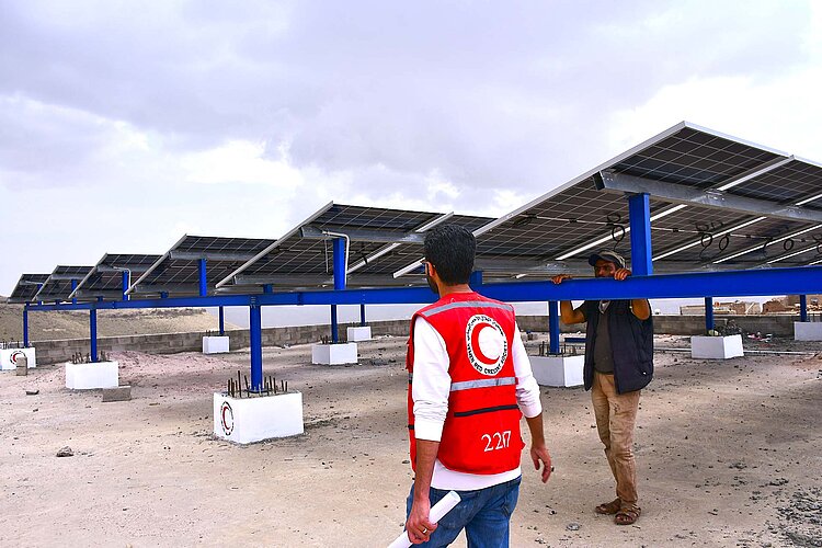 Staff in front of solar panels