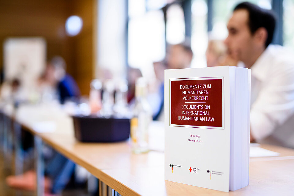 Humanitäres Völkerrecht Buch auf einem Konferenztisch