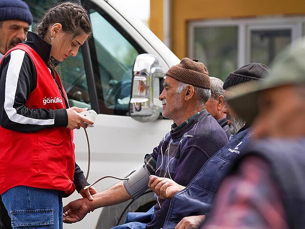 Young woman provides first aid to senior citizen