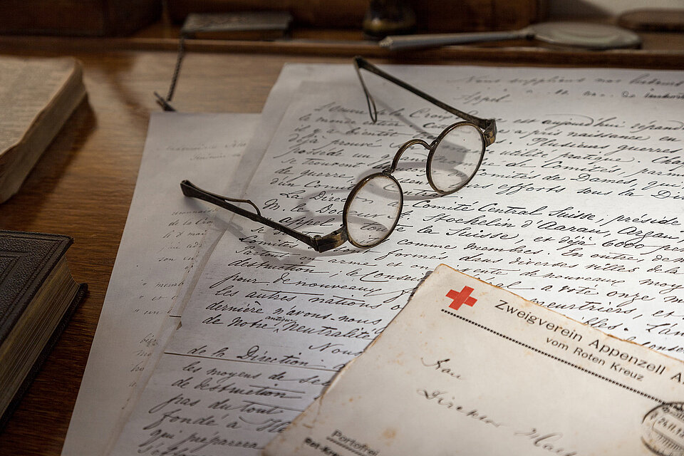 Aufzeichnung und Brille auf Holztisch